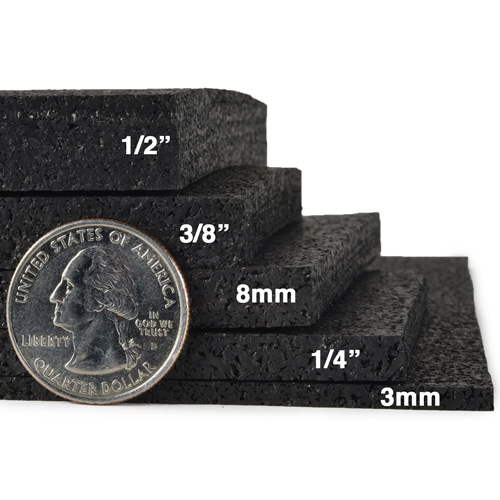 ![Different thickness options of black gym rubber flooring with a quarter for scale](#placeholder_link)